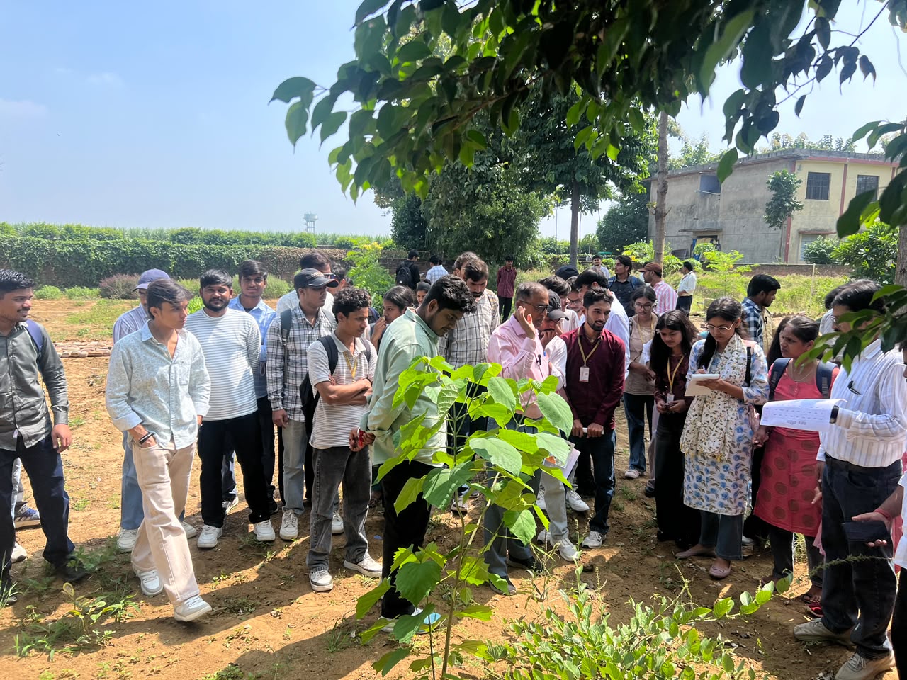 Students observing a plant demonstration during practical training in the garden